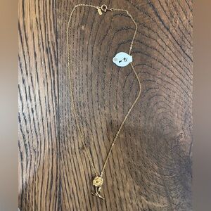 gold-tone necklace with a rose pendant